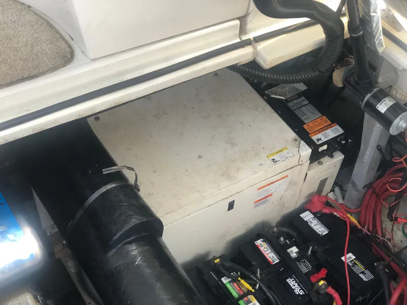 Slide: The Image of Engine compartment of 2001 Cruisers Yachts 3672 Express with visible batteries and wiring. - 13