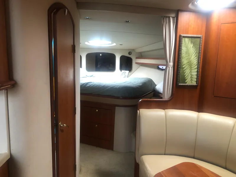 Slide: The Image of Interior of 2001 Cruisers Yachts 3672 Express, featuring cozy cabin and seating area. - 24