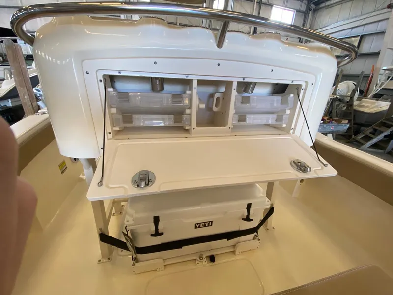 Slide: The Image of 2025 Scout 240 XSF boat interior with storage compartments and Yeti cooler. - 10