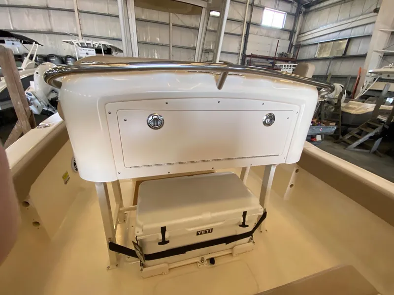 Slide: The Image of 2025 Scout 240 XSF boat interior with storage compartment and Yeti cooler. - 11