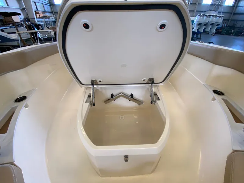 Slide: The Image of Open storage compartment on 2025 Scout 240 XSF boat in a showroom. - 17