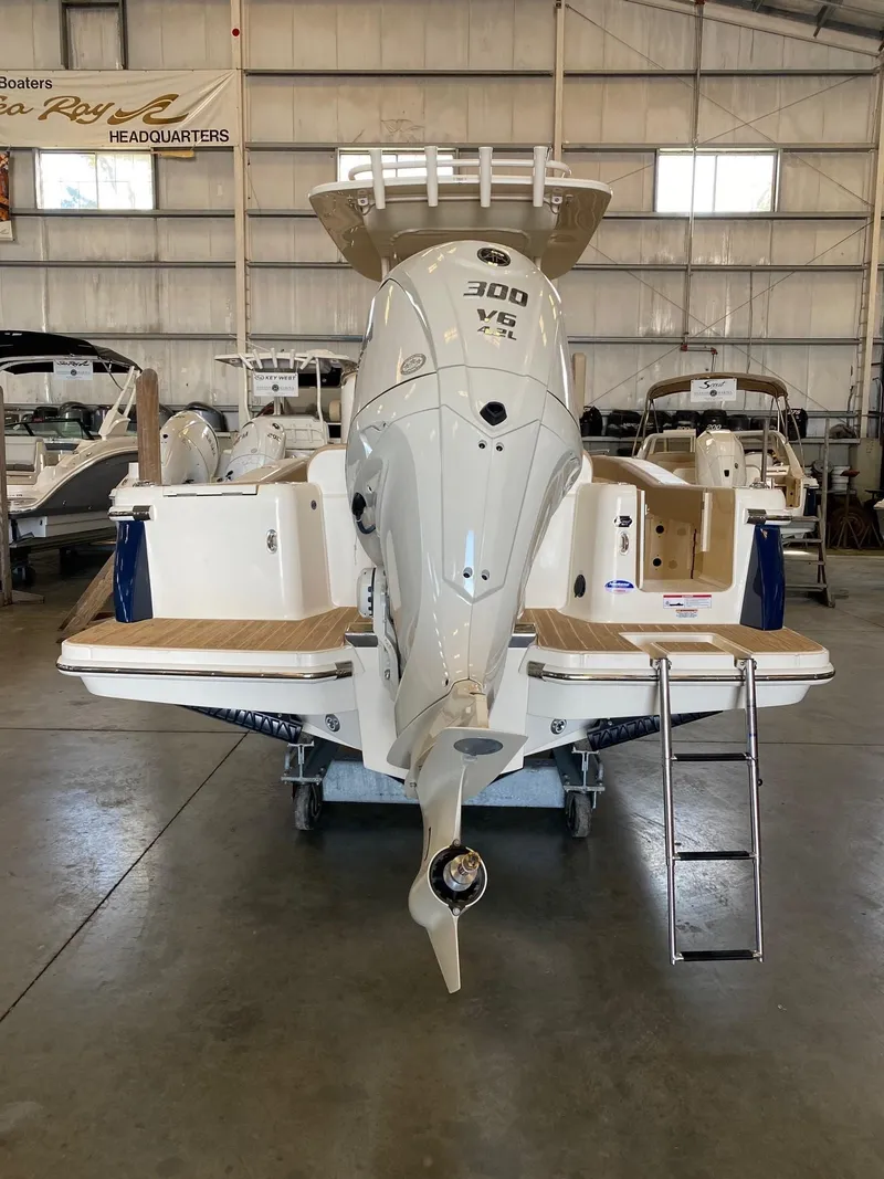 Slide: The Image of 2025 Scout 240 XSF boat with powerful 300 V6 engine in showroom. - 2