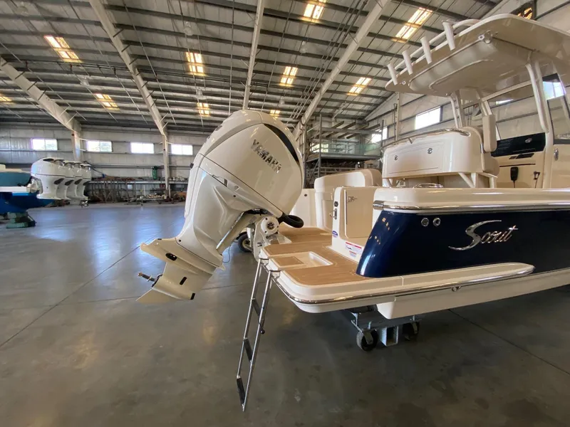 Slide: The Image of 2025 Scout 240 XSF boat in a warehouse, featuring a powerful outboard motor. - 3