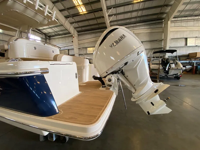 Slide: The Image of 2025 Scout 240 XSF boat with Yamaha outboard motor in a warehouse setting. - 4