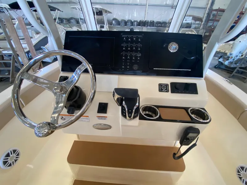 Slide: The Image of 2025 Scout 240 XSF boat dashboard with steering wheel and control panel. - 7