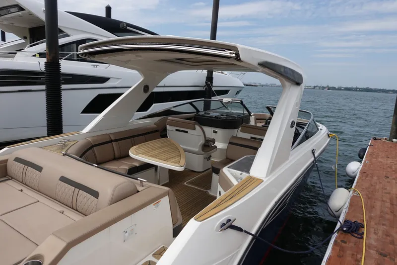 Slide: The Image of 2017 Sea Ray SLX 310 boat docked, featuring spacious seating and sleek design. - 1