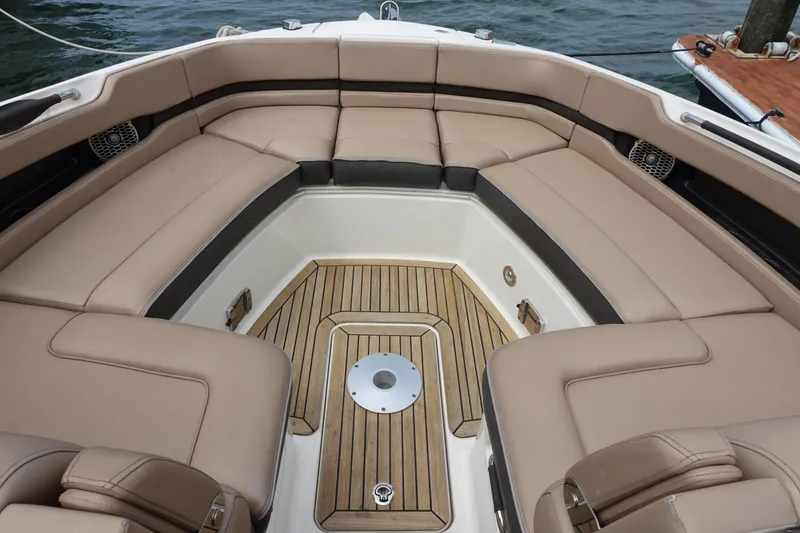 Slide: The Image of Luxurious 2017 Sea Ray SLX 310 boat interior with tan seating and teak flooring. - 12