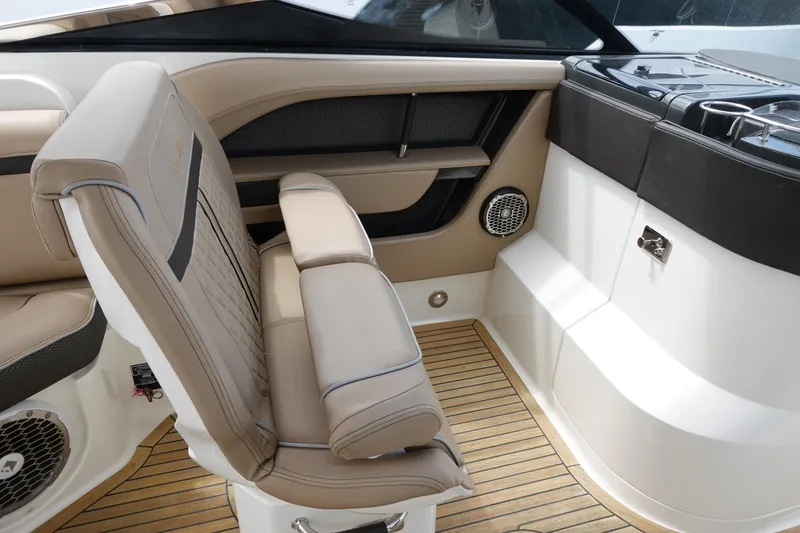 Slide: The Image of 2017 Sea Ray SLX 310 interior with beige seating and teak flooring. - 15