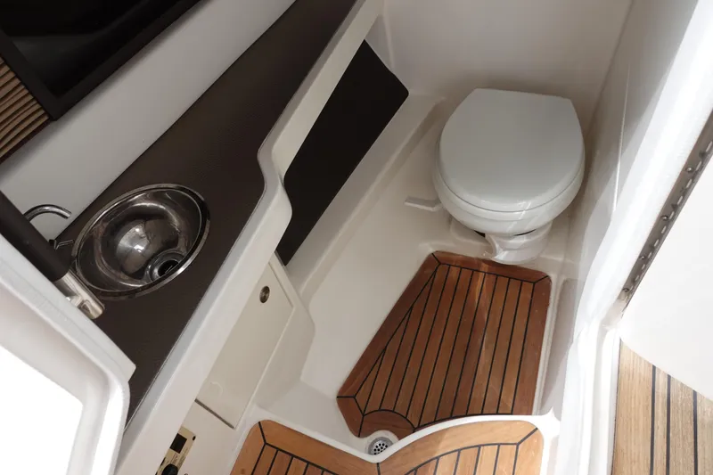 Slide: The Image of 2017 Sea Ray SLX 310 boat bathroom with sink and wooden flooring. - 19
