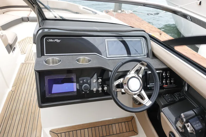 Slide: The Image of 2017 Sea Ray SLX 310 helm with modern controls and sleek design. - 5