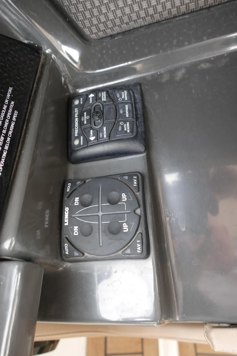 Slide: The Image of Control panel of a 2017 Sea Ray SLX 310 boat, featuring navigation and trim controls. - 7