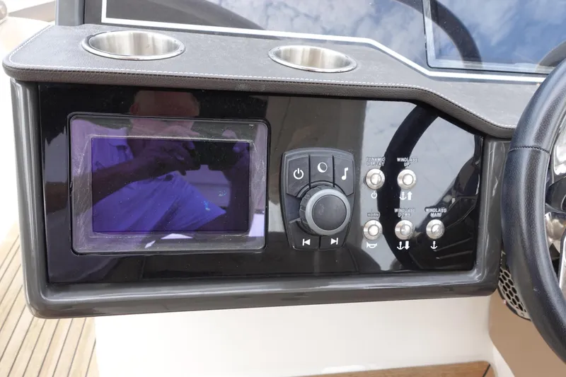 Slide: The Image of Control panel of 2017 Sea Ray SLX 310 boat with cup holders and navigation controls. - 8