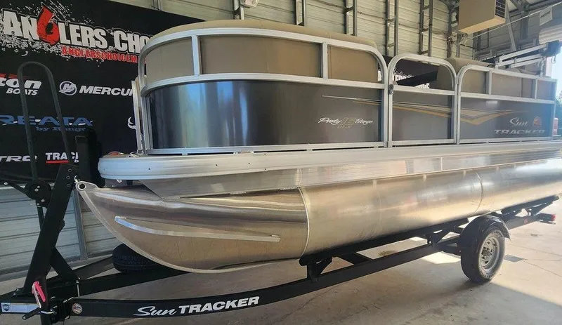 Slide: The Image of 2025 Sun Tracker PARTY BARGE® 16 DLX pontoon boat on trailer in garage. - 11