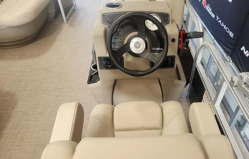 Slide: The Image of 2025 Sun Tracker PARTY BARGE® 16 DLX helm with beige seating and steering wheel. - 5