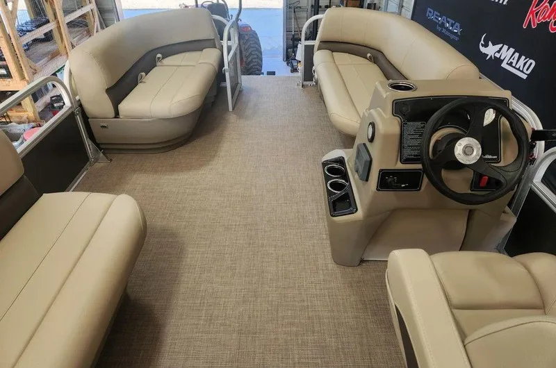 Slide: The Image of 2025 Sun Tracker PARTY BARGE® 16 DLX interior with beige seating and steering console. - 6