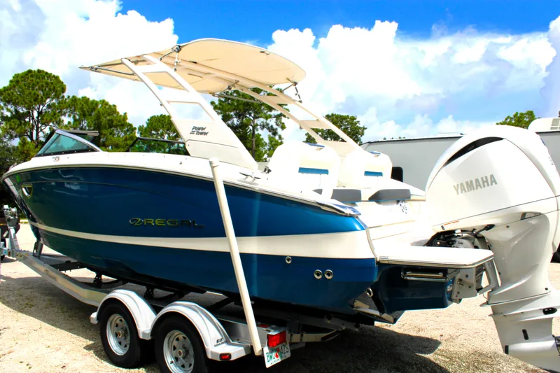 Slide: The Image of 2023 Regal LX6 boat on trailer with Yamaha engine, parked outdoors. - 10