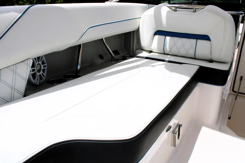 Slide: The Image of 2023 Regal LX6 boat interior with white and black seating, blue accents. - 27
