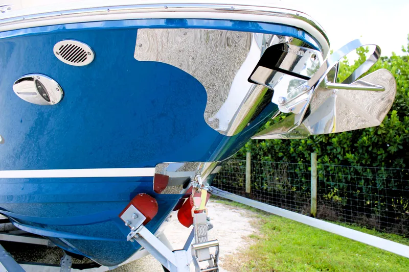 Slide: The Image of 2023 Regal LX6 boat with shiny blue hull and chrome details. - 3