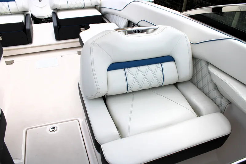 Slide: The Image of Luxurious seating on 2023 Regal LX6 boat with white and blue upholstery. - 38