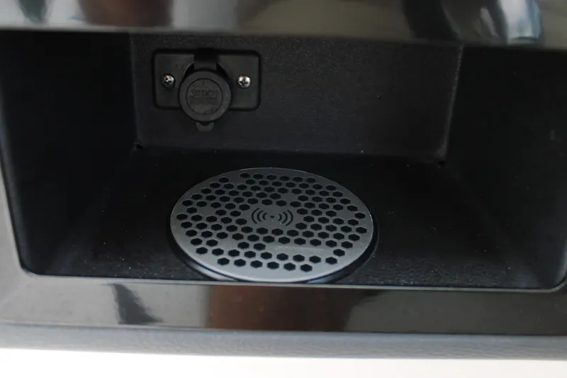 Slide: The Image of 2023 Regal LX6 boat compartment with charging port and speaker grille. - 41