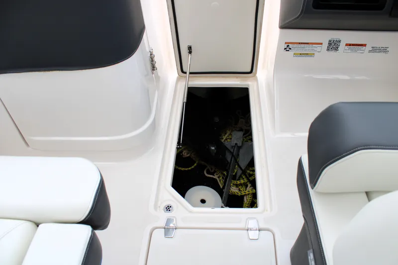 Slide: The Image of 2023 Regal LX6 boat storage compartment with open hatch, showcasing interior space and seating. - 45