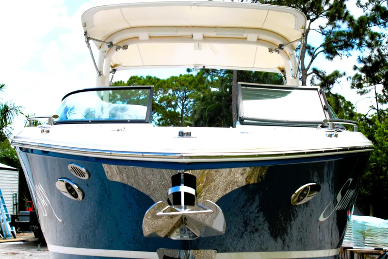 Slide: The Image of 2023 Regal LX6 boat with sleek design and modern features, docked outdoors. - 5
