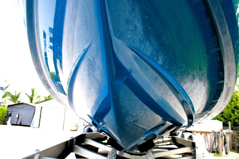 Slide: The Image of 2023 Regal LX6 boat hull on trailer, close-up view. - 7