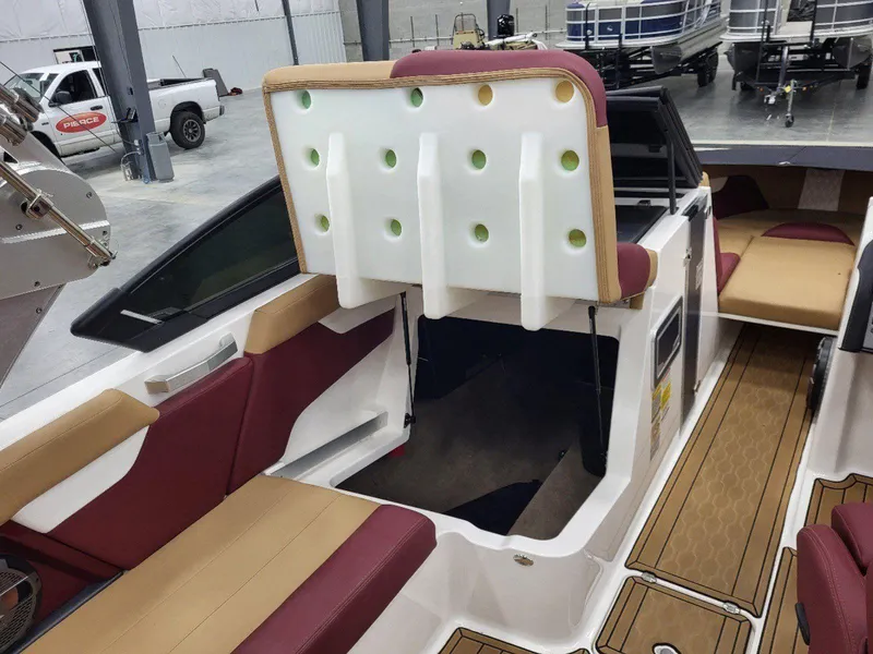 Slide: The Image of 2022 MasterCraft XT23 interior with red and tan seating, showcasing modern design and spacious layout. - 17