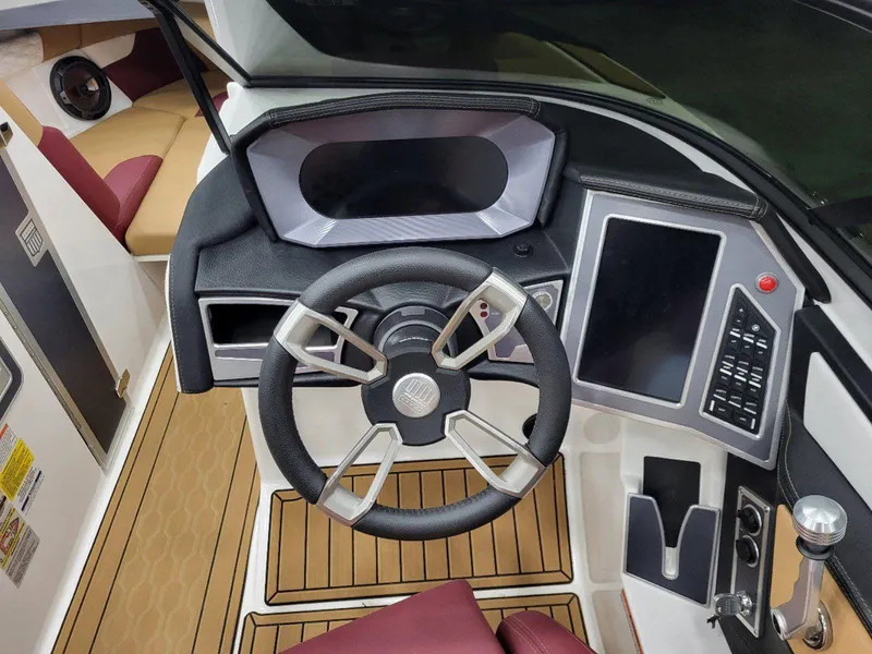 Slide: The Image of 2022 MasterCraft XT23 boat dashboard with steering wheel and control panel. - 18