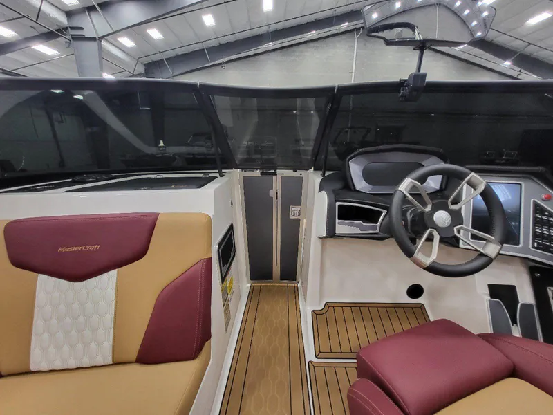 Slide: The Image of 2022 MasterCraft XT23 boat interior with modern dashboard and luxurious seating. - 20