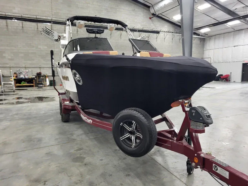 Slide: The Image of 2022 MasterCraft XT23 boat on trailer in indoor storage facility. - 31
