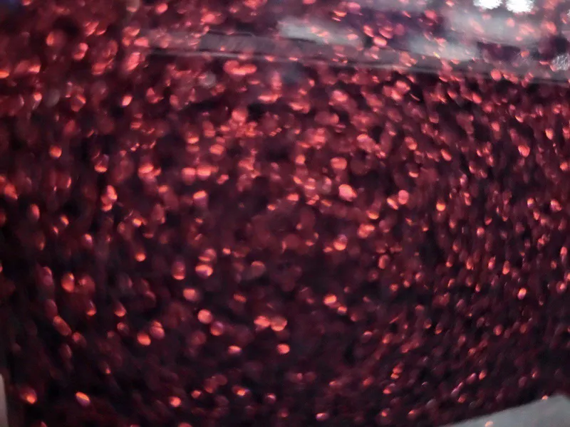 Slide: The Image of Blurred red and black abstract pattern, possibly a close-up of a textured surface. - 34