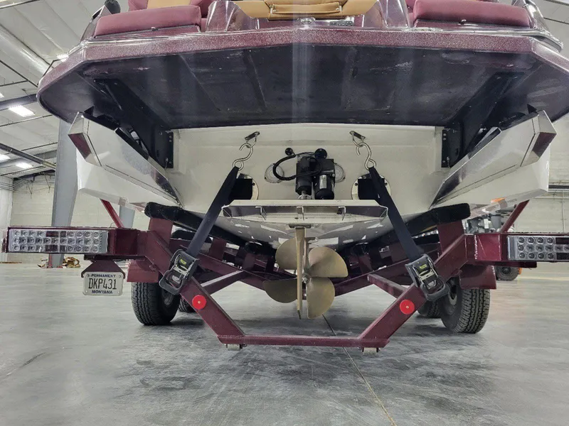 Slide: The Image of 2022 MasterCraft XT23 boat on trailer in indoor storage facility. - 5