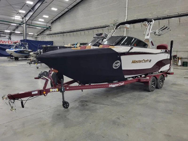Slide: The Image of 2022 MasterCraft XT23 boat on trailer in indoor storage facility. - 8