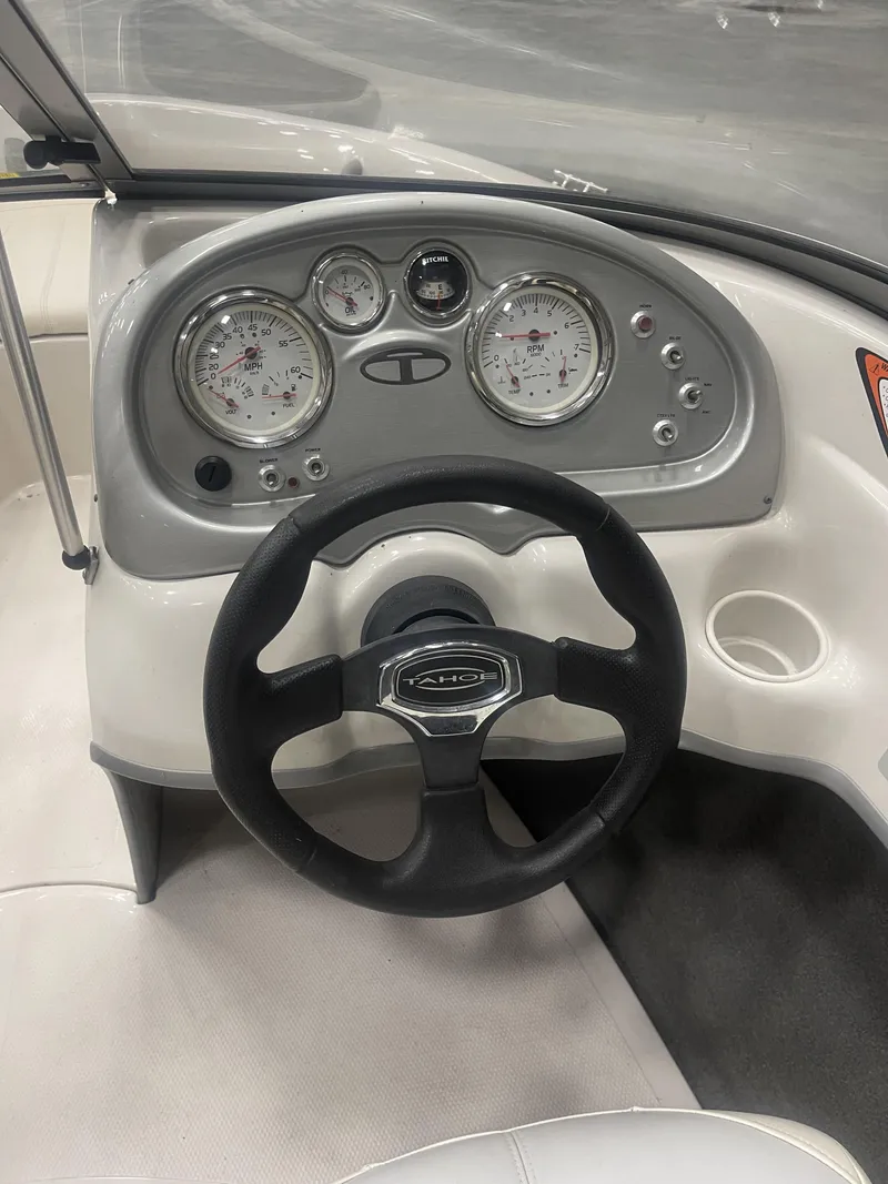Slide: The Image of 2010 Tracker TAHOE Q4 boat dashboard with steering wheel and gauges. - 10