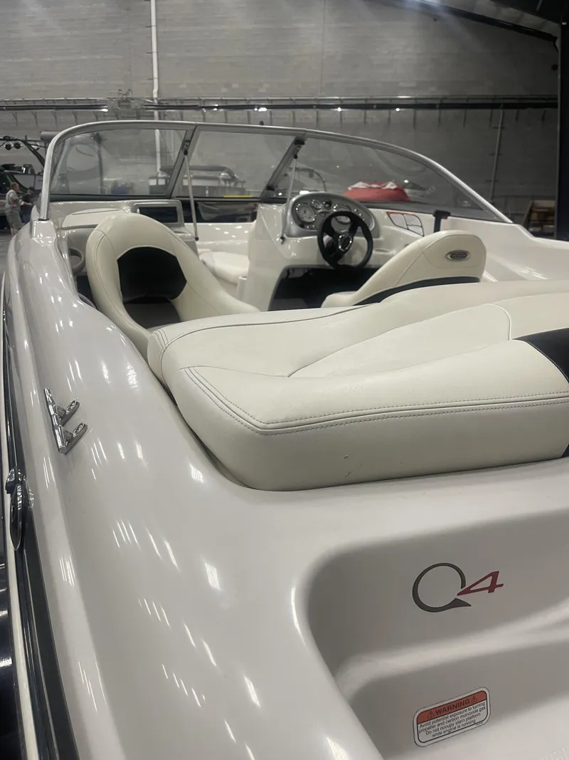 Slide: The Image of 2010 Tracker TAHOE Q4 boat interior with white seating and steering wheel. - 4