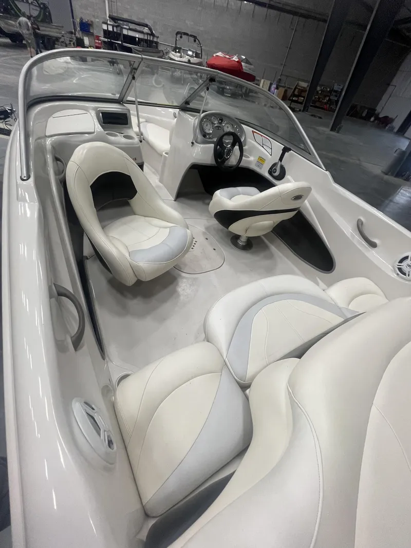 Slide: The Image of 2010 Tracker TAHOE Q4 boat interior with white seating and steering wheel. - 5