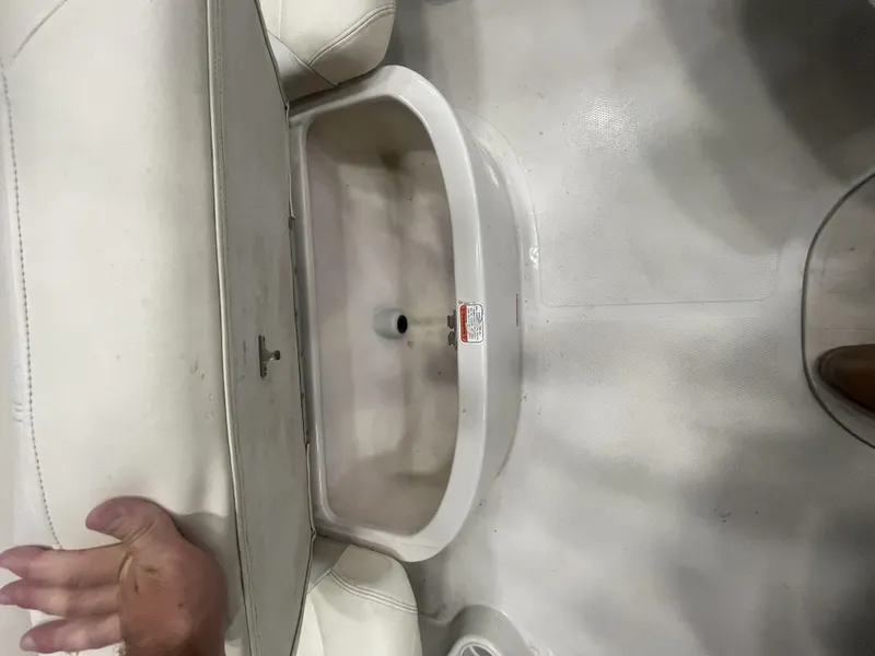 Slide: The Image of 2010 Tracker TAHOE Q4 boat interior storage compartment with white upholstery. - 6