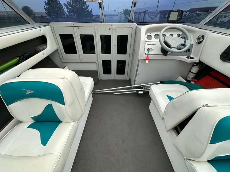 Slide: The Image of Interior of a 1993 RENEIL REINEL 2400RXL boat with white and teal seating. - 10