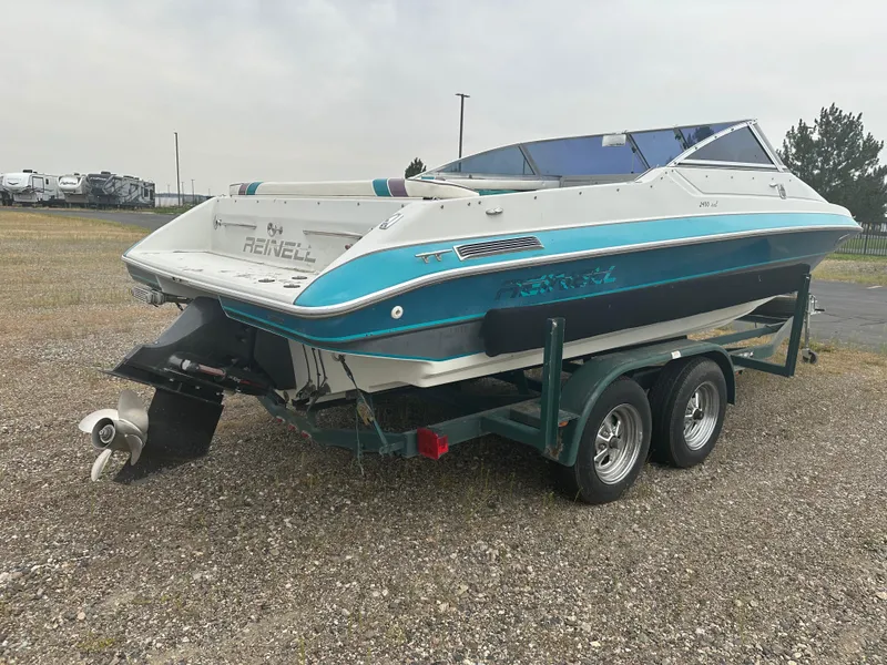 Slide: The Image of 1993 RENEIL REINEL 2400RXL boat on trailer, teal and white design. - 5