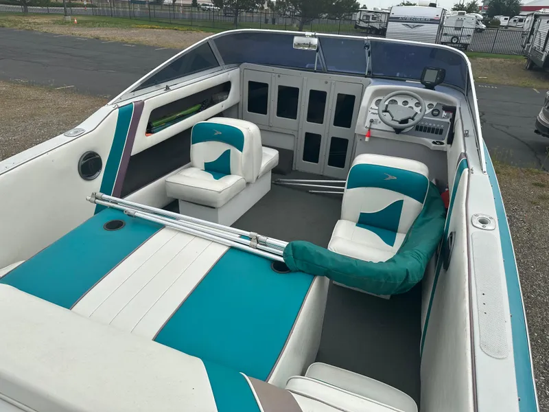 Slide: The Image of Interior of a 1993 RENEIL REINEL 2400RXL boat with teal and white seating. - 6