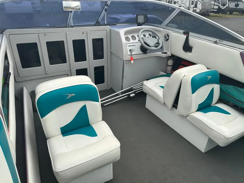 Slide: The Image of Interior of a 1993 RENEIL REINEL 2400RXL boat with teal and white seating. - 7