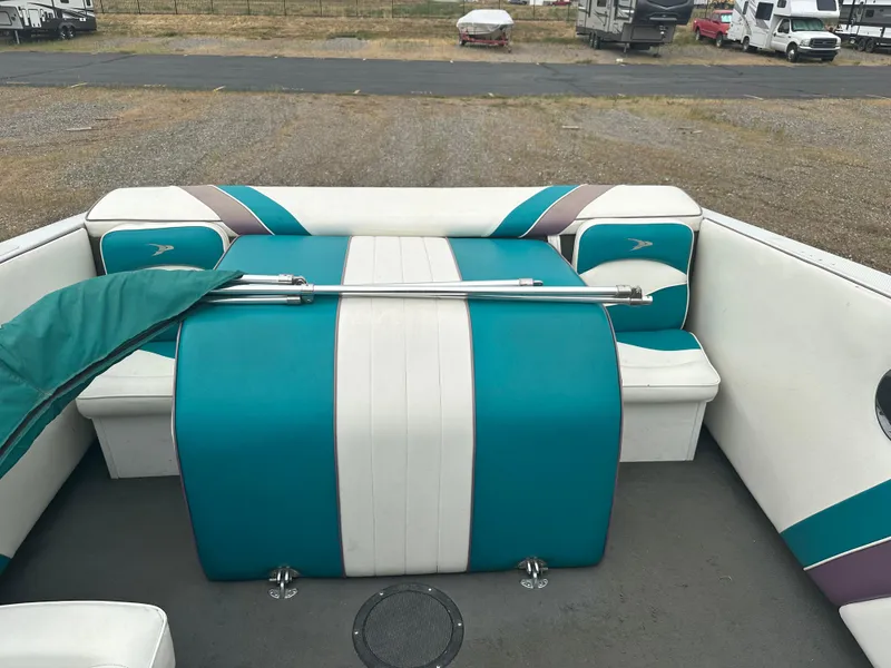 Slide: The Image of 1993 RENEIL REINEL 2400RXL boat interior with teal and white seating. - 8