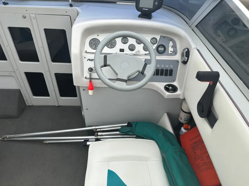 Slide: The Image of Boat cockpit of 1993 RENEIL REINEL 2400RXL with steering wheel and control panel. - 9