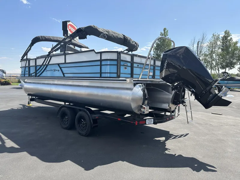 Slide: The Image of 2023 Forest River SOUTH BAY 224FCR pontoon boat on trailer, outdoor display. - 3