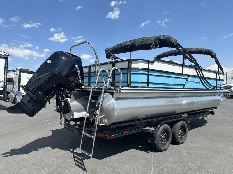 Slide: The Image of 2023 Forest River SOUTH BAY 224FCR pontoon boat on trailer, blue sky background. - 4