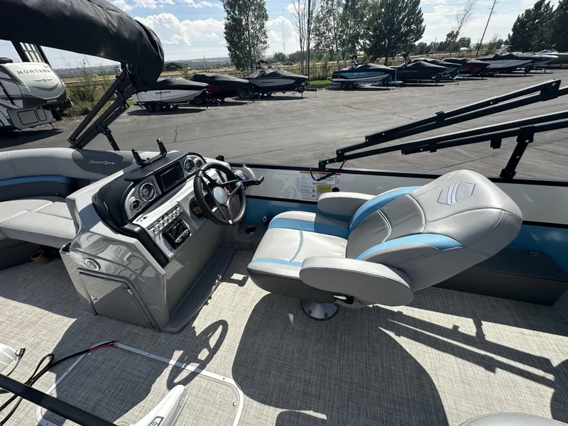 Slide: The Image of 2023 Forest River SOUTH BAY 224FCR boat interior with steering console and captain's chair. - 6