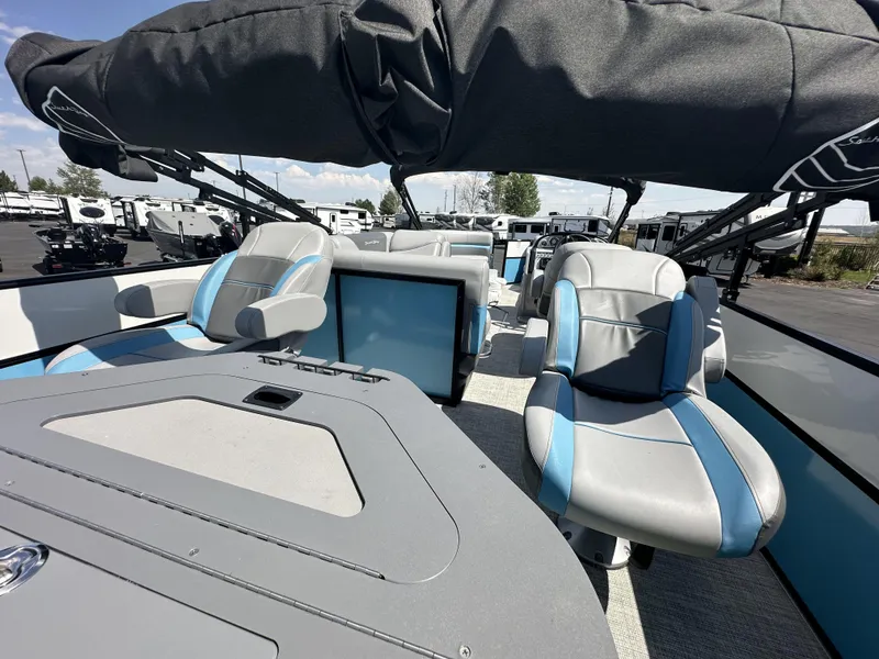 Slide: The Image of 2023 Forest River SOUTH BAY 224FCR pontoon boat interior with blue and gray seating. - 8