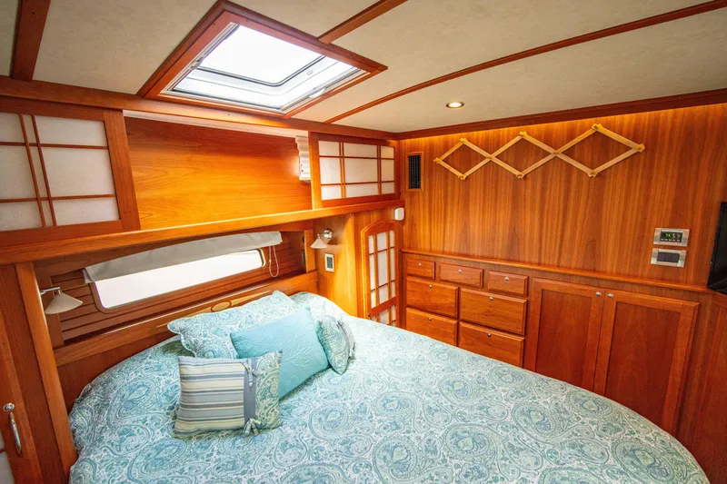 Slide: The Image of Luxurious 2015 Sabre 48 Salon Express bedroom with wood paneling and skylight. - 12