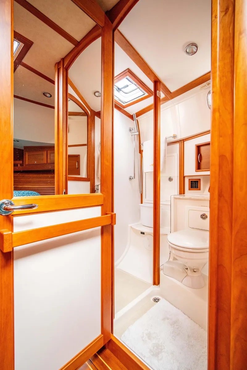 Slide: The Image of Luxurious bathroom in 2015 Sabre 48 Salon Express yacht with wood accents and modern fixtures. - 15